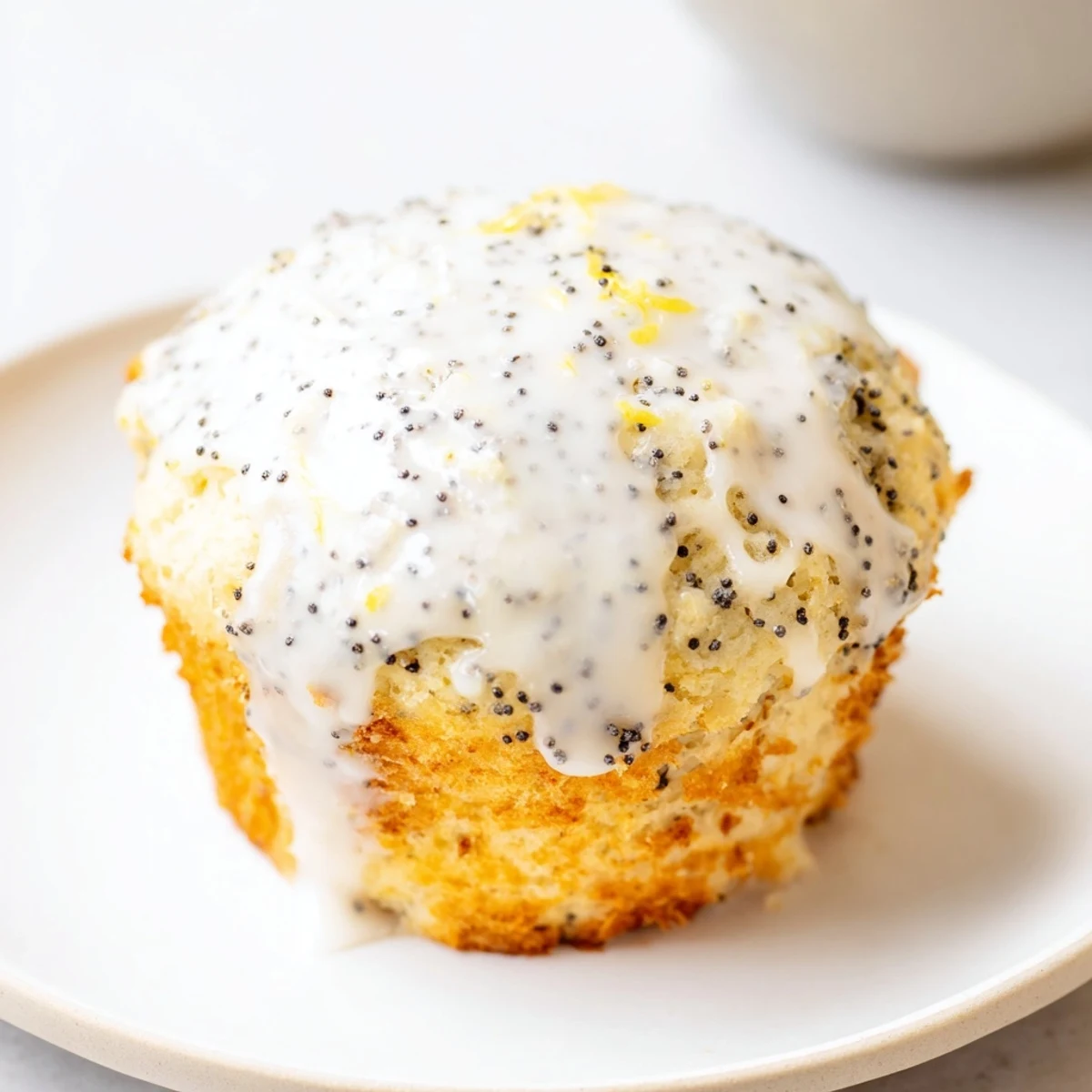 Warm Lemon Poppy Seed Muffins with Lemon Glaze drizzled over the tops, perfect for breakfast or an afternoon snack.