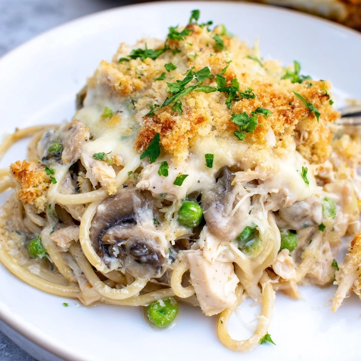 Golden-brown Turkey Tetrazzini bubbling from the oven with melted cheese and panko topping