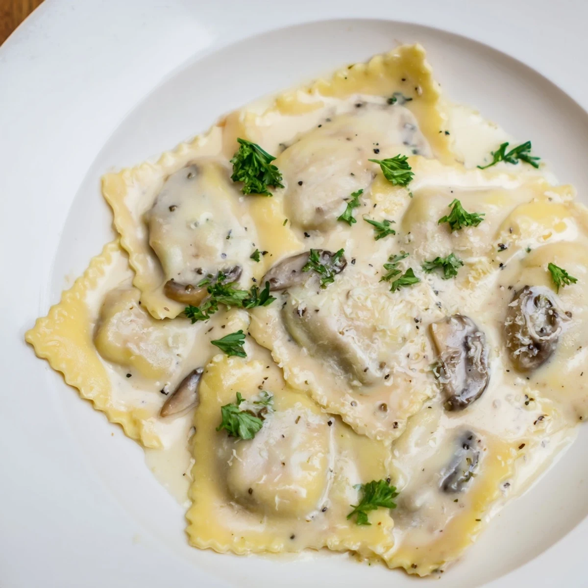 Steaming ravioli filled with savory mushrooms and ricotta, drizzled with silky truffle oil and garnished with fresh parsley.