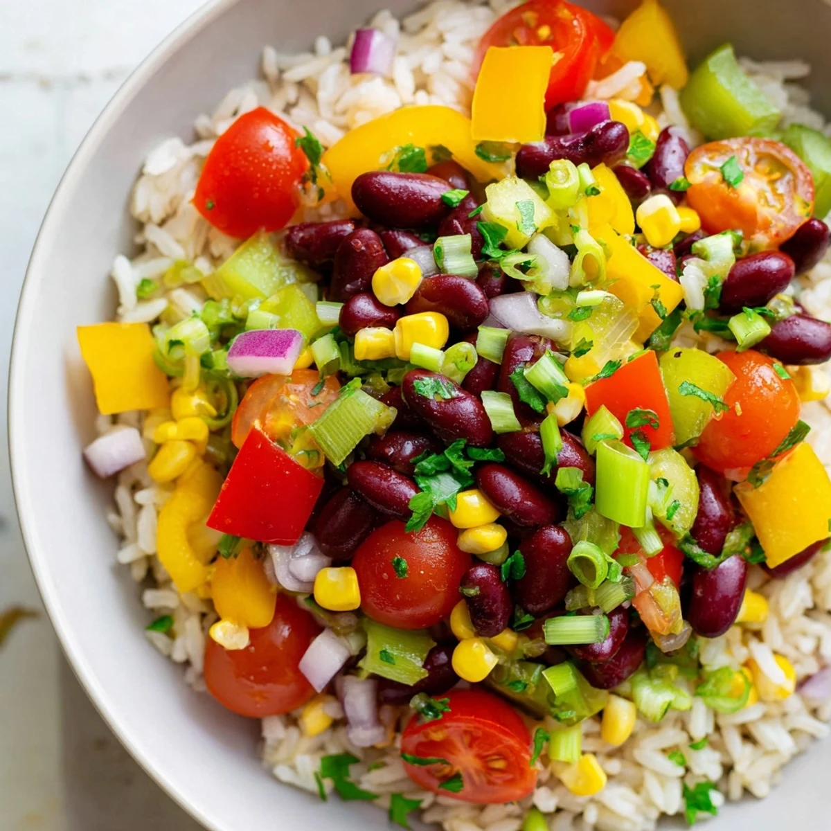 A steaming bowl of Mardi Gras Veggie Rice Bowl with sautéed peppers and beans.