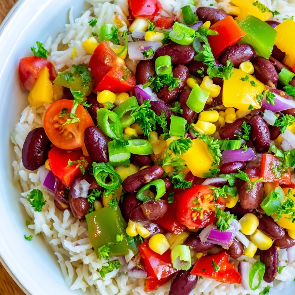 Mardi Gras Veggie Rice Bowl garnished with green onions and a drizzle of hot sauce.