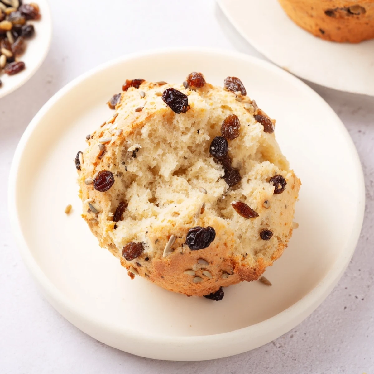 Close-up of tender Irish Soda Bread Muffins studded with plump raisins and caraway seeds.