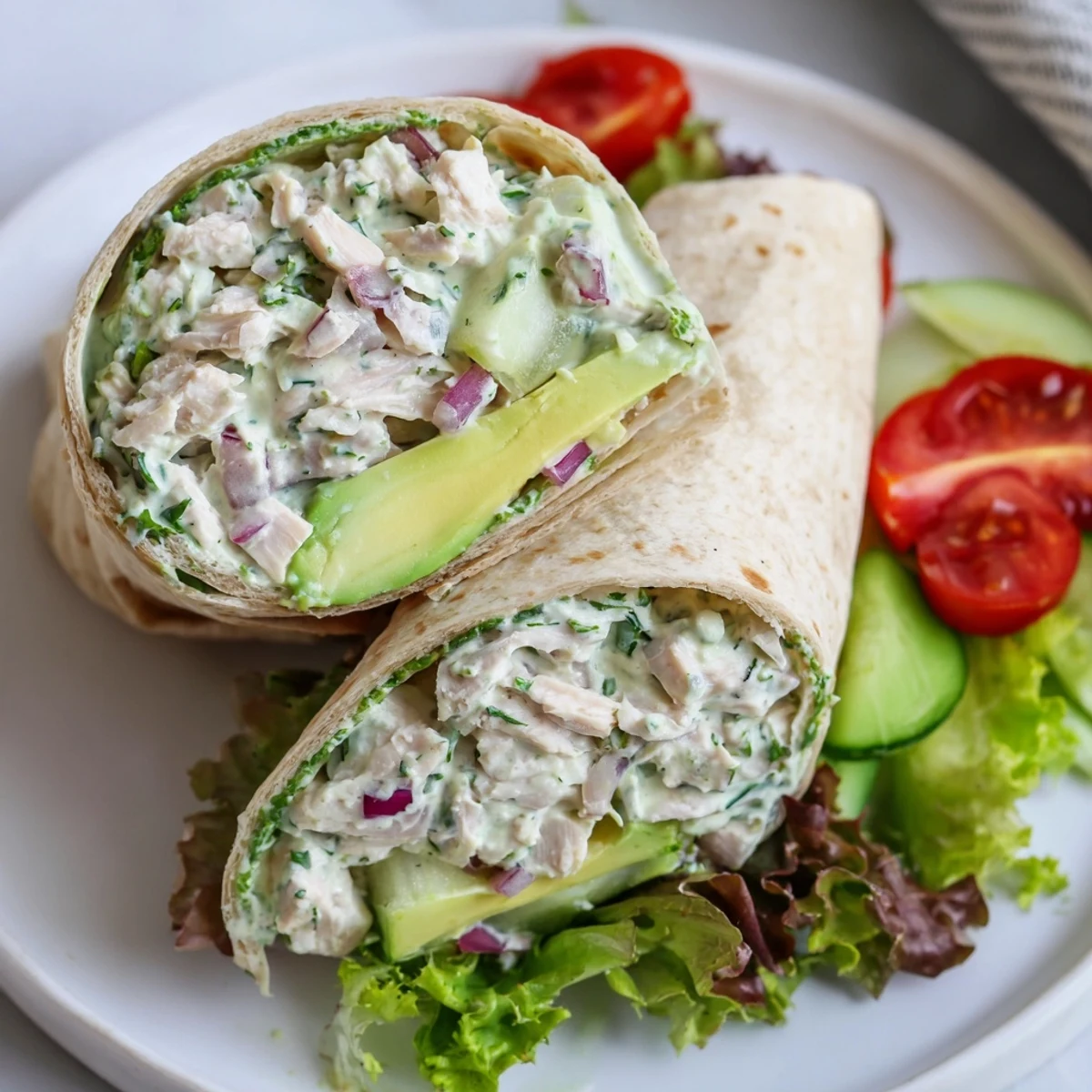 The close-up captures juicy cucumbers, shredded chicken, and arugula for a healthy, high-protein American lunch.