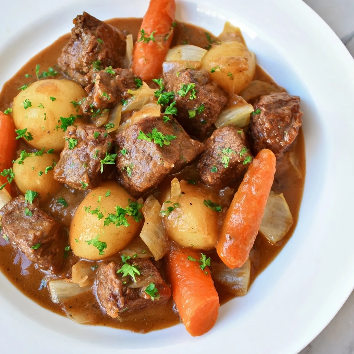 Irish Beef Stew with Rich Brown Gravy in a rustic pot shows meaty beef, root vegetables, and a thick, aromatic gravy ready to serve.