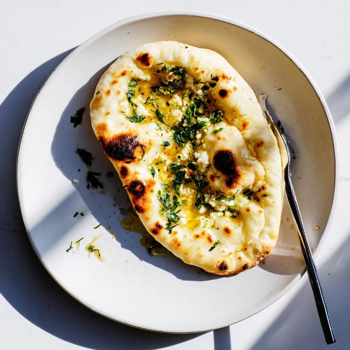 Soft, pillowy Cottage Cheese Garlic Naan topped with aromatic garlic butter, ready to be torn and enjoyed at dinner.