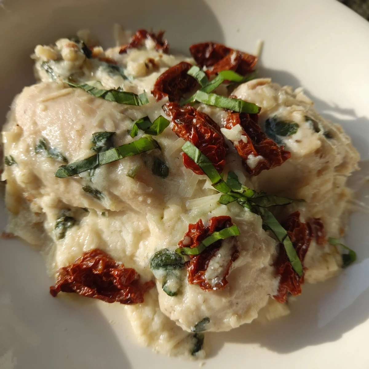 A close-up of the Marry Me Low Carb Chicken Casserole bubbling with golden mozzarella and sun-dried tomatoes.