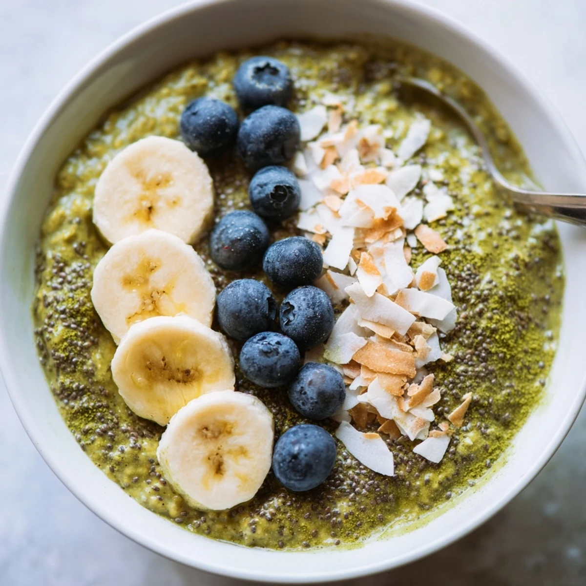Overnight oats topped with berries in a glass jar, matching the matcha protein overnight oats recipe.