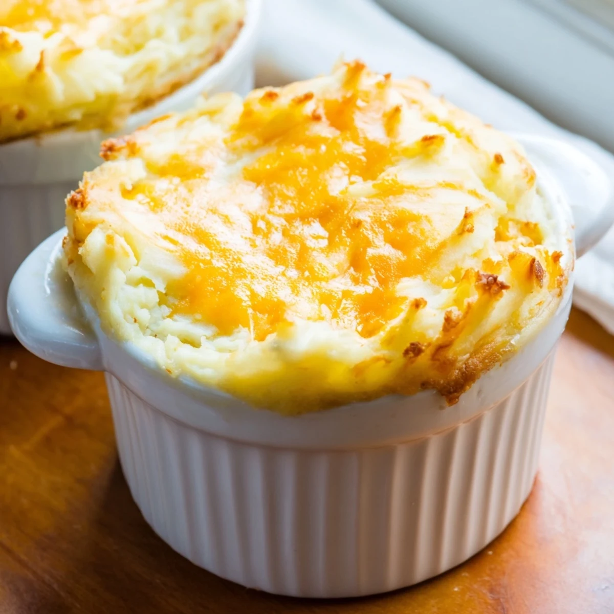 Golden-brown Mini Shepherds Pie with creamy mashed potato swirls, baked to bubbly perfection with savory beef filling.