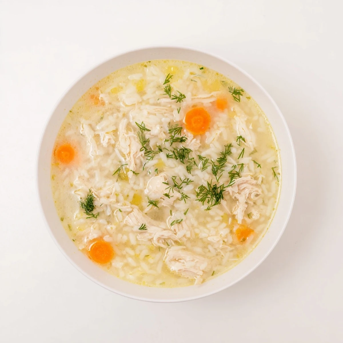 Creamy Avgolemono Greek Lemon Chicken Soup with tender shredded chicken pieces in bright yellow broth