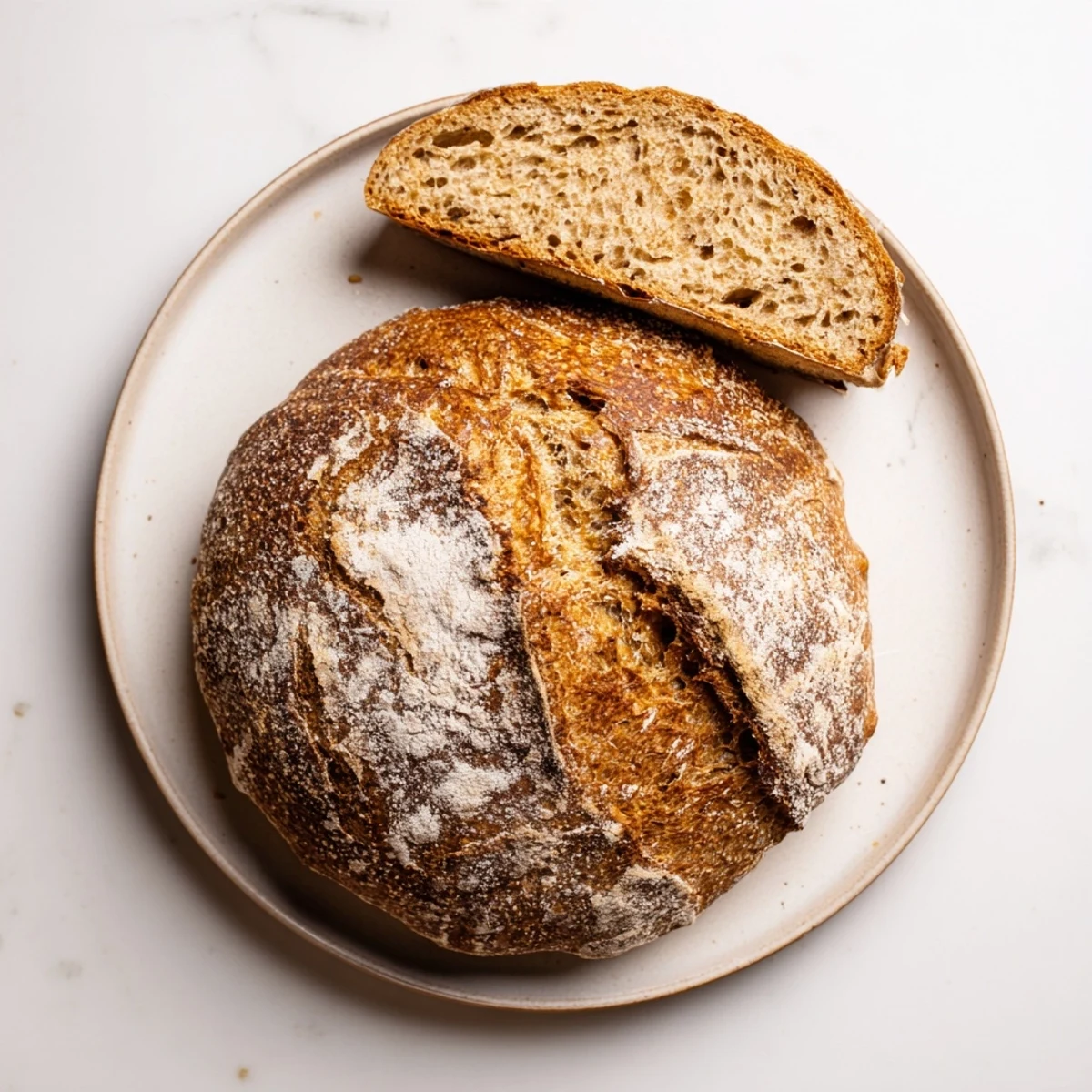 Homemade artisan no knead bread loaf with crispy crust served on wire cooling rack