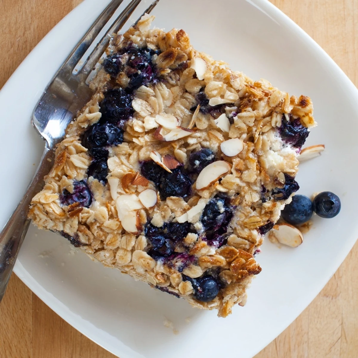 Fresh baked blueberry cottage cheese breakfast bake in a square dish with golden brown topping
