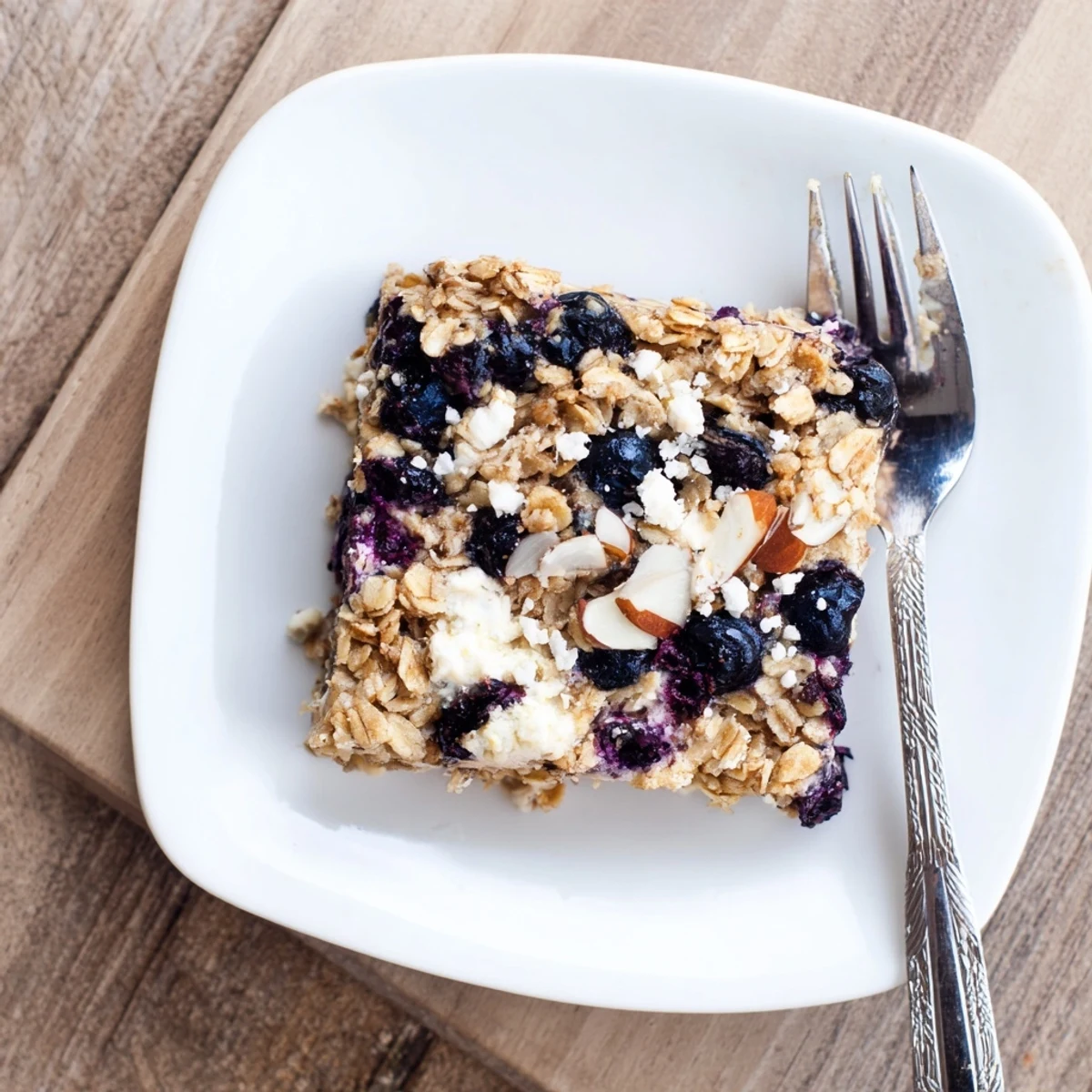 Sliced blueberry cottage cheese breakfast bake served warm showing creamy texture and plump baked fruit