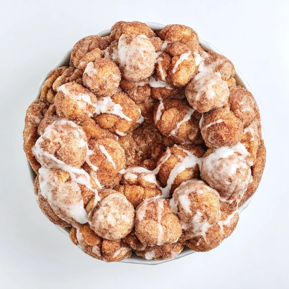Pull-apart high protein no sugar monkey bread sprinkled with sweet cinnamon in a bundt pan
