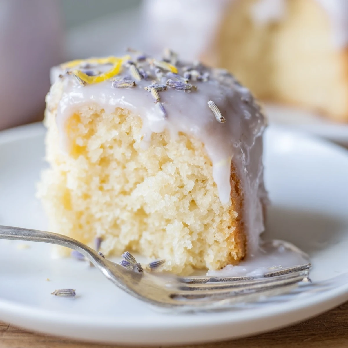 Mini lemon cakes with lavender glaze served on a vintage afternoon tea plate