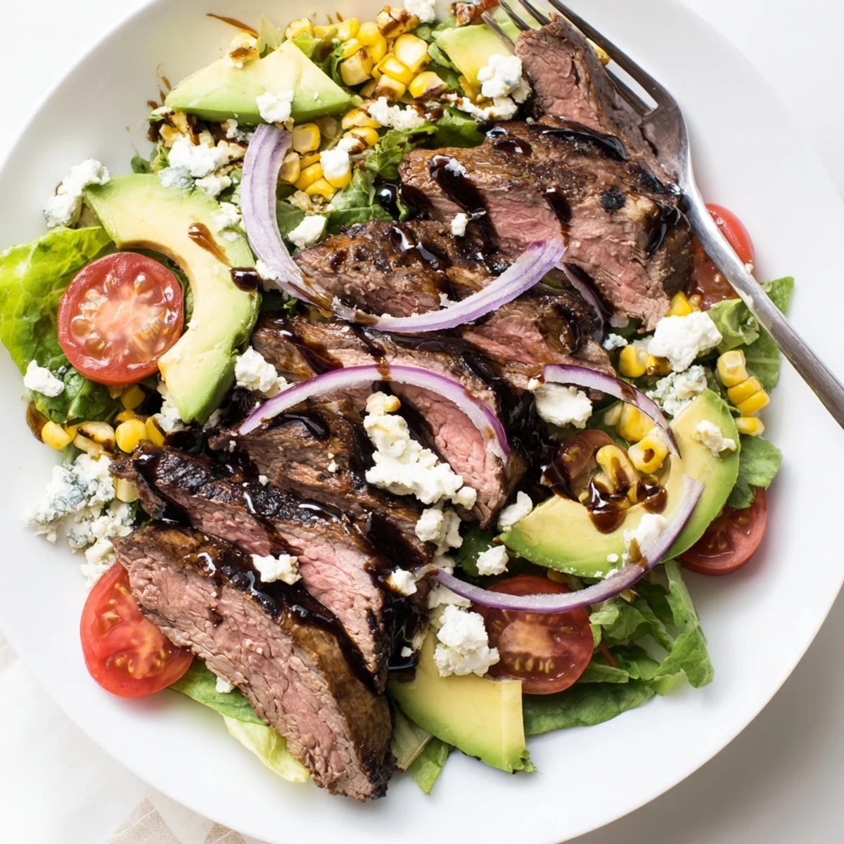 Crisp greens topped with charred corn crumbled Gorgonzola and balsamic-marinated grilled steak