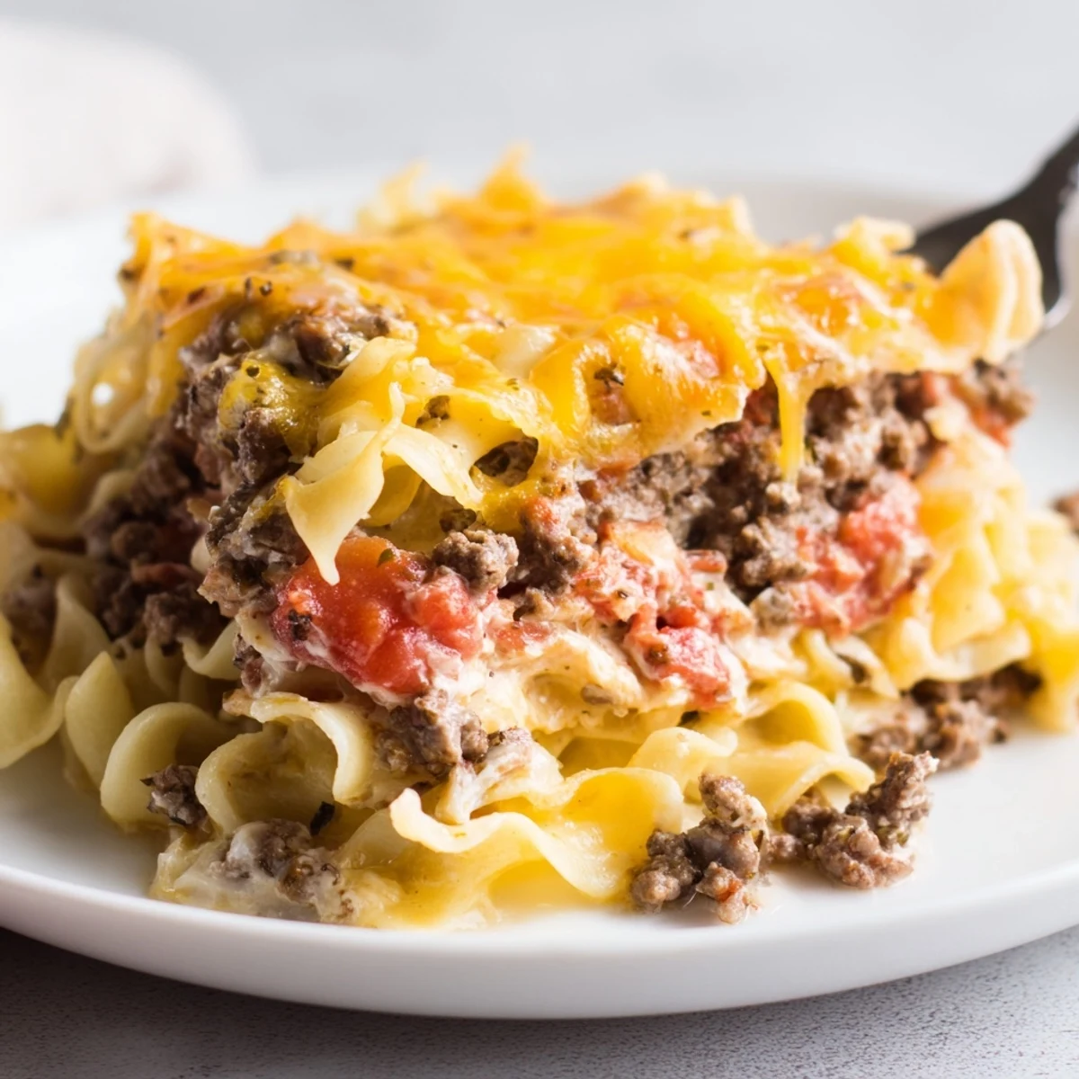 Hearty Beef Lombardi Casserole layered with noodles, tomato sauce, creamy cottage cheese