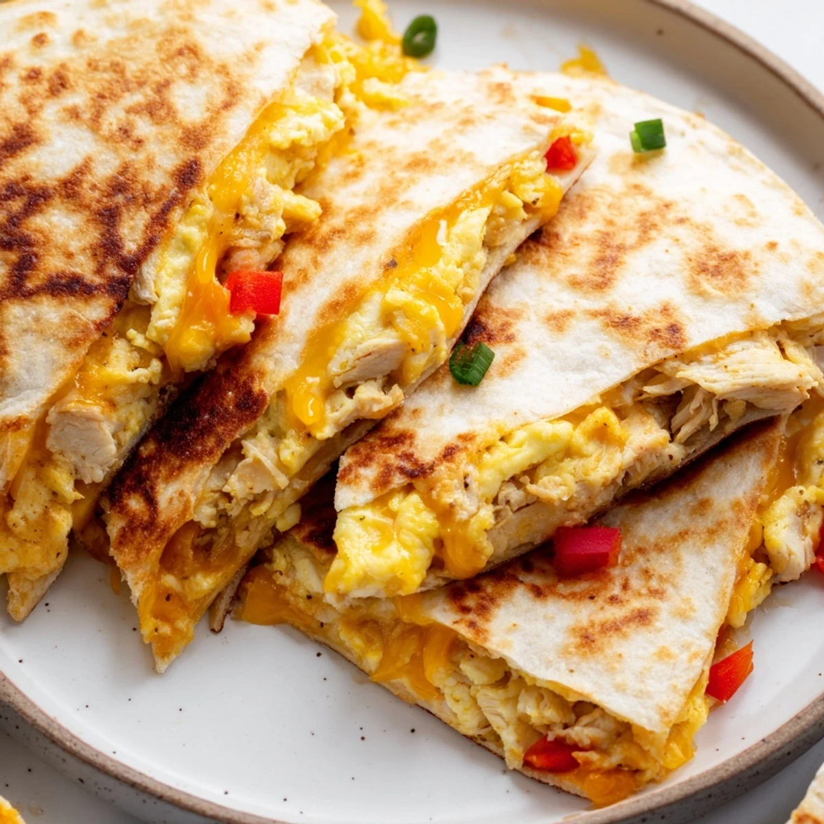 Golden, crispy Chicken Breakfast Quesadilla sliced into wedges with melty cheddar.