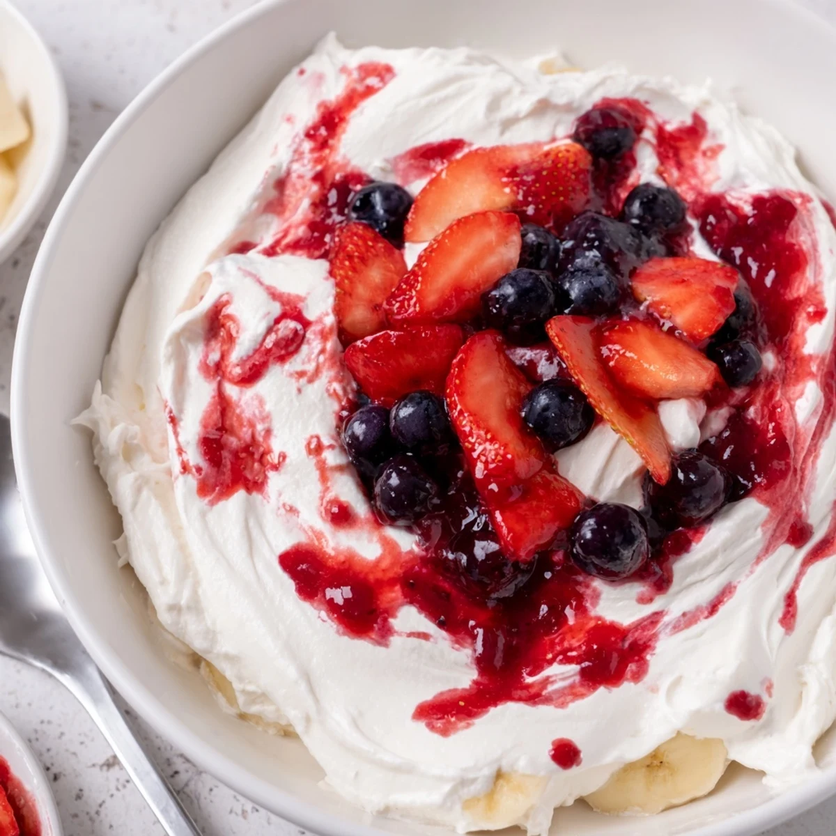 Chilled Red White And Blue Cheesecake Salad served at summer picnics, garnished