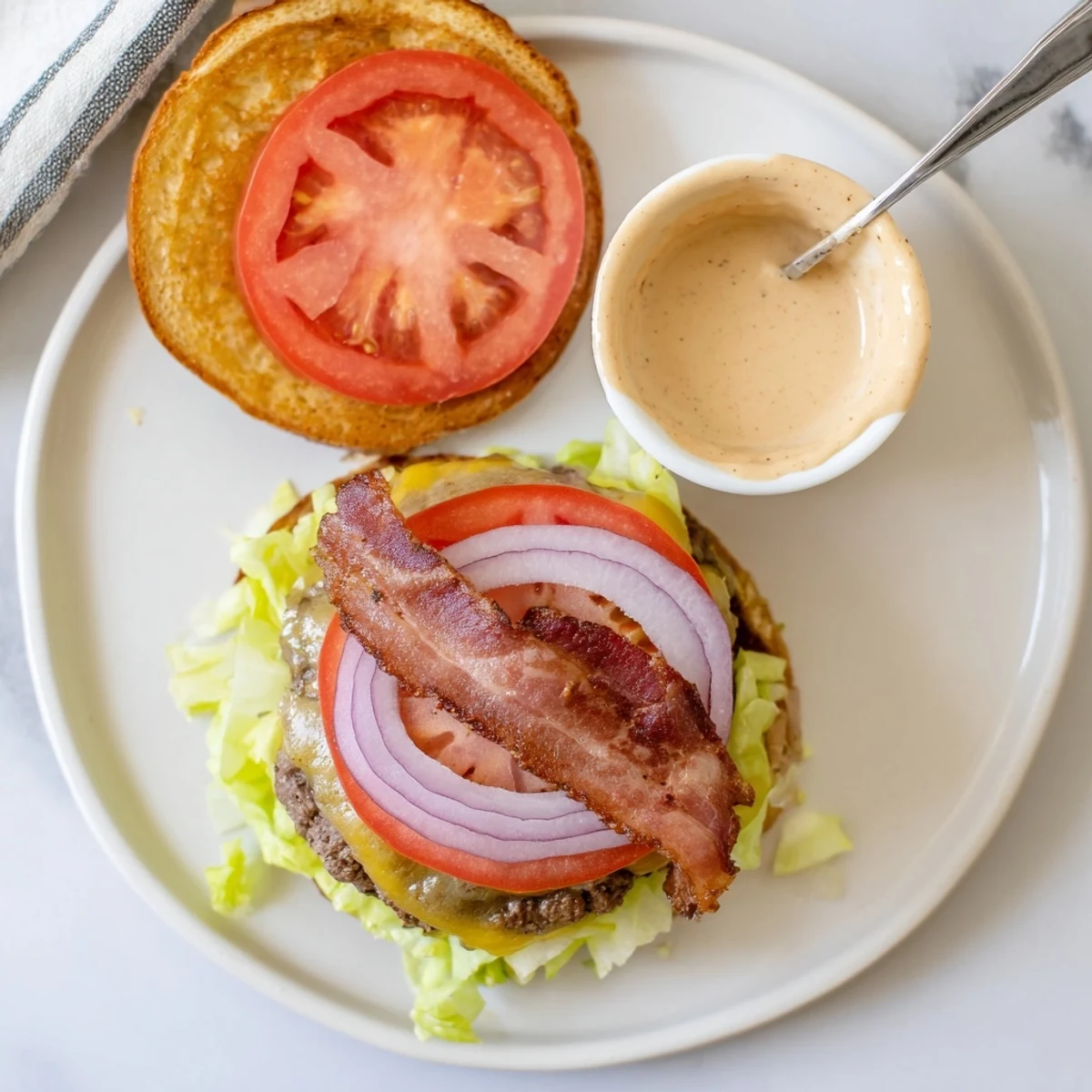 Irresistible Crack Burgers glistening with melted cheddar, bacon, and tangy crack sauce