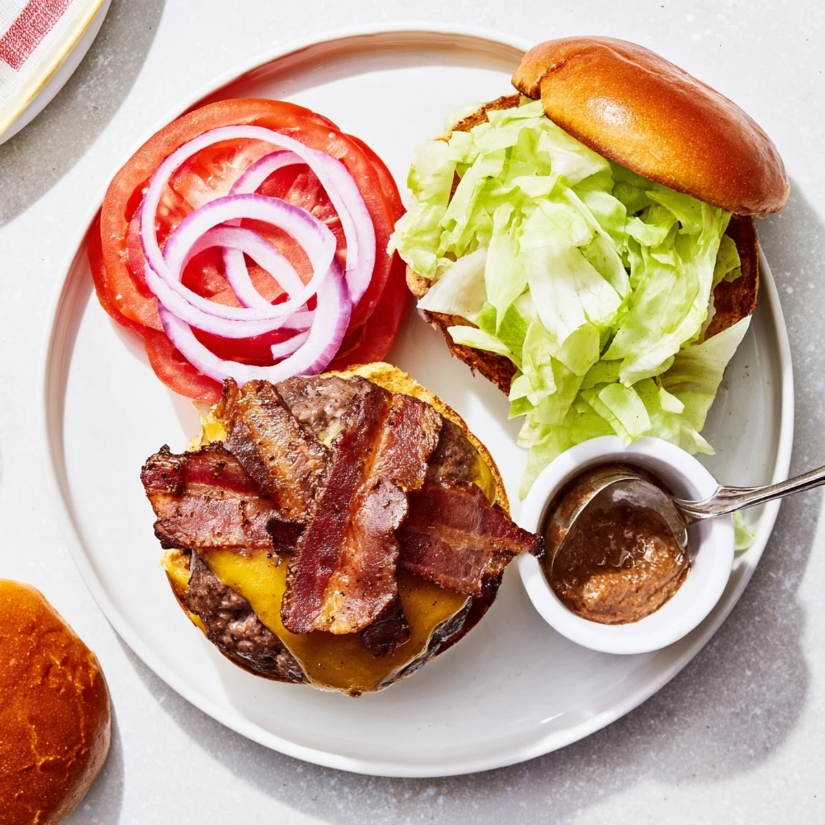 Halved Irresistible Crack Burgers oozing cheese, crispy bacon, served with fries