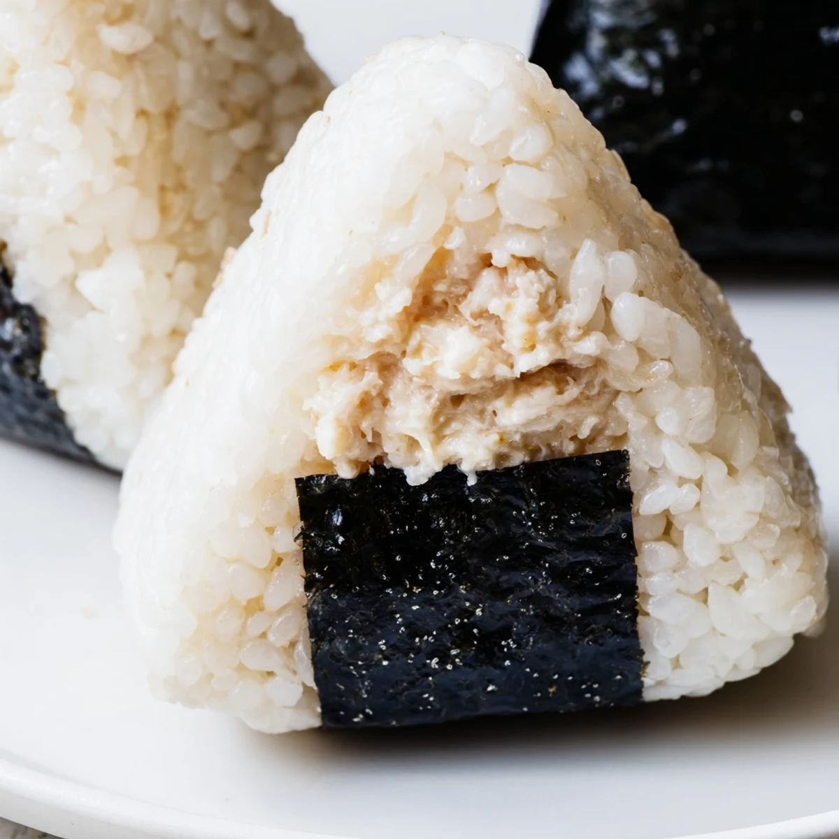 Creamy tuna mayonnaise stuffed inside fluffy Japanese rice ball for portable lunch