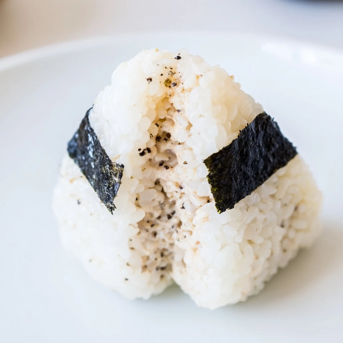 Golden rice triangle filled with savory tuna mayo and garnished with nori