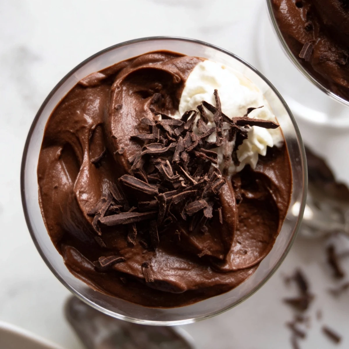 Velvety chocolate mousse served in elegant glasses topped with chocolate shavings