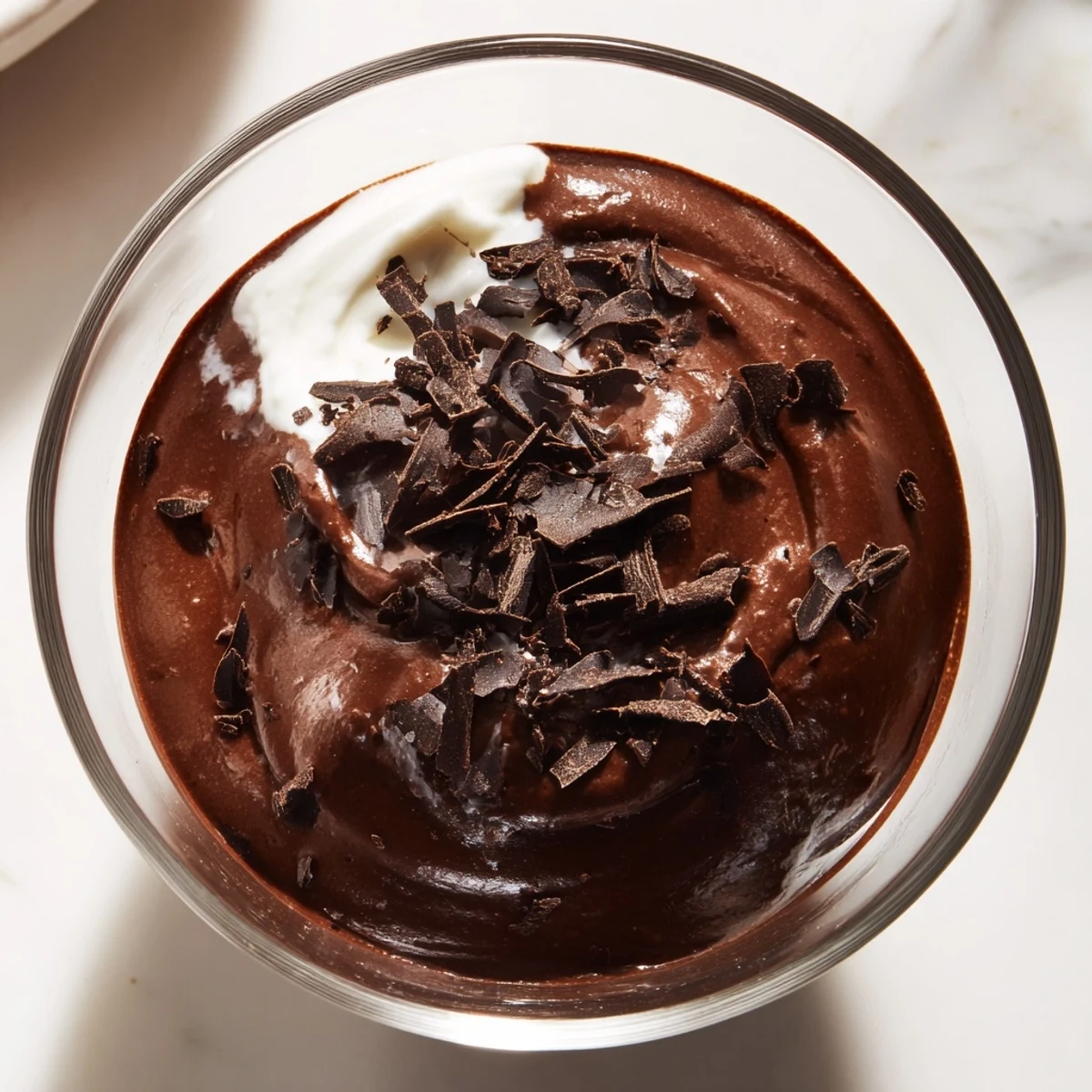 Silky smooth chocolate mousse in dessert cups dusted with cocoa powder