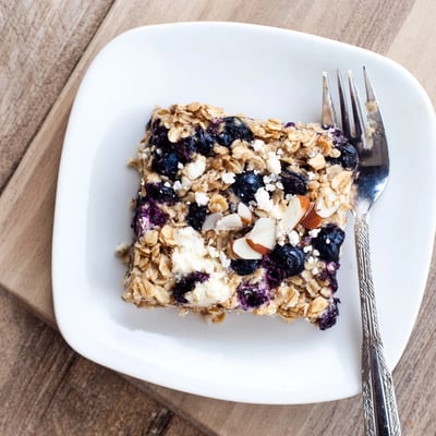 Sliced blueberry cottage cheese breakfast bake served warm showing creamy texture and plump baked fruit