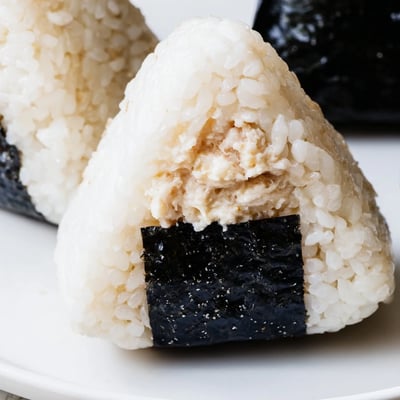 Creamy tuna mayonnaise stuffed inside fluffy Japanese rice ball for portable lunch
